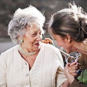 Caregiver meeting with older adult