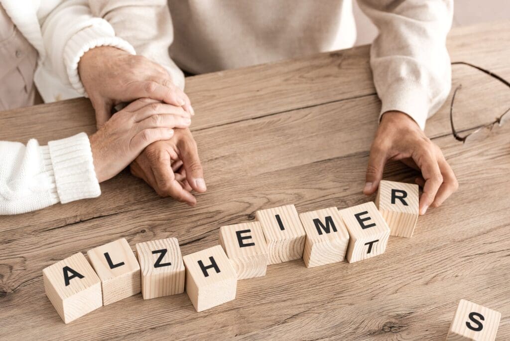 Alzheimers and older adults as shown in blocks and frail hands. Geromind works with Alzheimer's patients